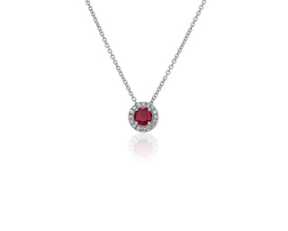 A 14k white gold pendant with a ruby and diamond halo (5mm)