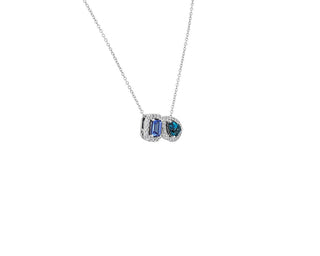 Two-stone pendant set in 14k white gold with tanzanite and blue topaz with a diamond halo.