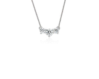 Triple-stone pendant with floating diamonds in platinum, (1 carat total weight)