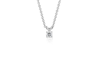 A 1/3 carat total weight platinum pendant set with a princess-cut diamond.