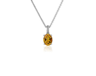 An oval pendant set in 14k white gold with citrine and diamonds (8x6mm)