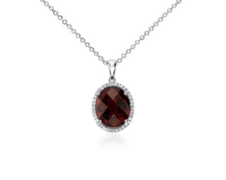 Sterling silver oval pendant with a halo of white sapphire and garnet (12x10mm)