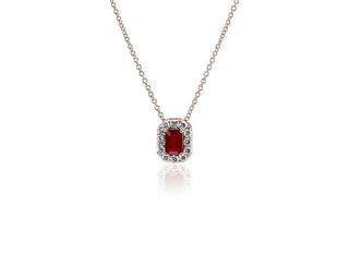 A 14k rose gold pendant with an emerald cut ruby and diamond halo (6x4mm)