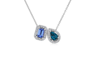 Two-stone pendant set in 14k white gold with tanzanite and blue topaz with a diamond halo.