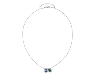 Two-stone pendant set in 14k white gold with tanzanite and blue topaz with a diamond halo.